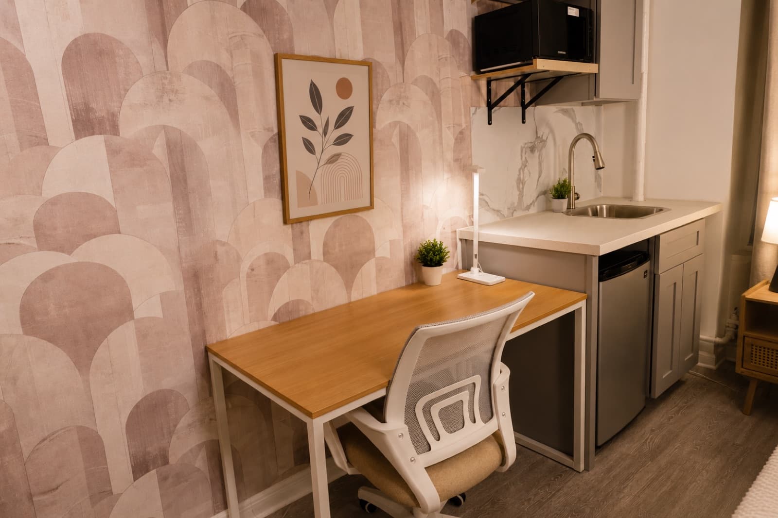 Furnished studio with private shower at Amsterdam Place, Upper West Side NYC — kitchenette and workspace with Art Deco arch wallpaper